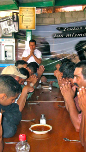 Men praying at the comedor at the Kino Border Initiative [Original Image Source: Jesuit Province of California]