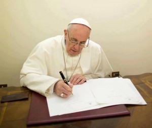 Pope Francis reviewing Laudato Si earlier this year.
