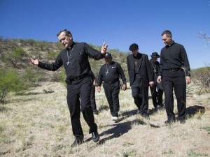 Bishop Elizondo leading other bishops and Jesuit Father Sean Carroll during a tour of Catholic facilities serving migrants in 2014. [SOURCE: USCCB]