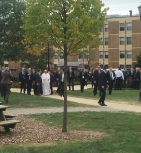 Pope Francis walks across Saint Joseph's University campus during his brief visit, the first for him to a U.S. Jesuit university campus.