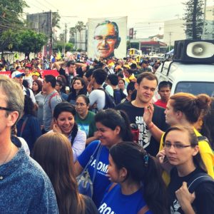 U.S. Jesuit university students participating in the CASA program join pilgrims in a procession in honor of Romero in March 2015. [Credit: Kevin Yonkers-Talz]