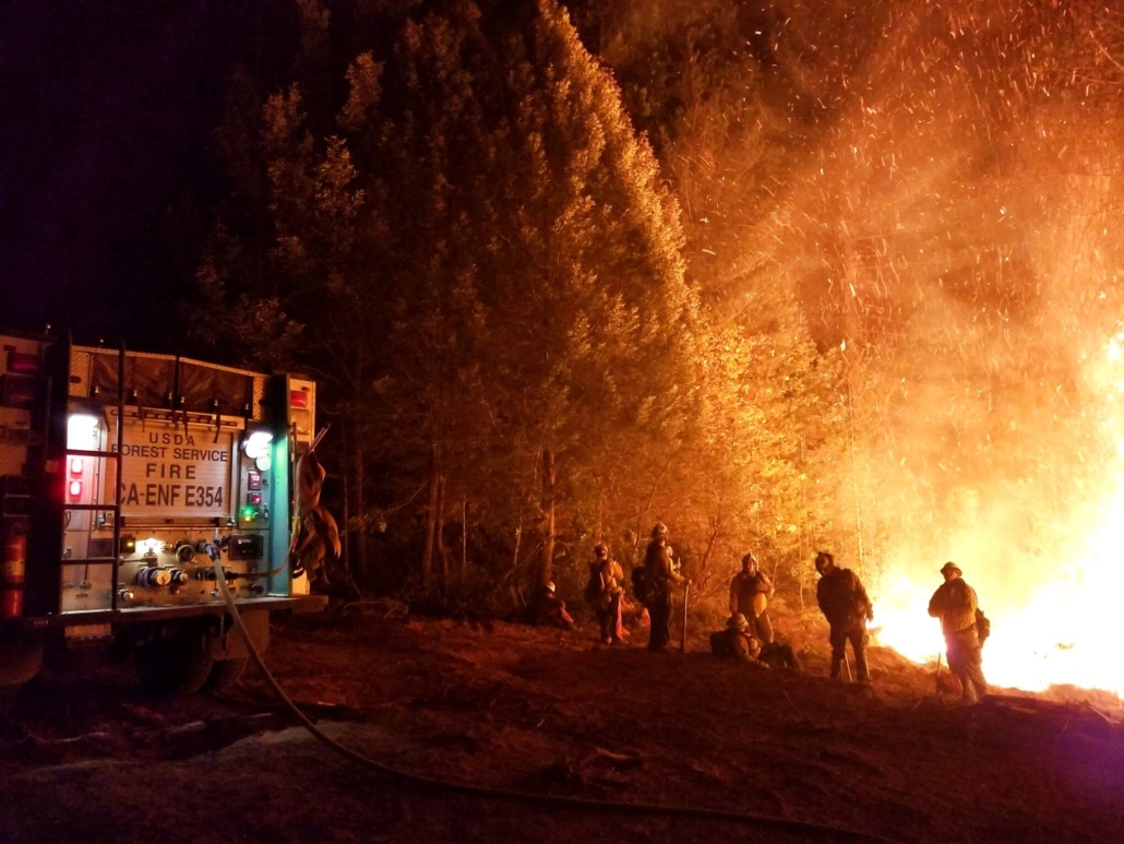 Firefighters fight camp fire